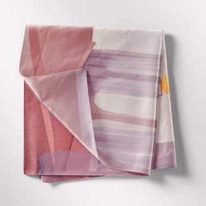 Detail showing smooth silky fabric texture and colorful abstract geometric print