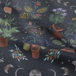 Close-up showing fabric texture with floral, moon phase and tree of life patterns