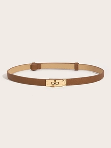 Detail of slim brown leather belt featuring a golden turn-lock buckle and cross-grain texture