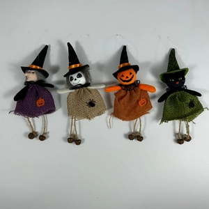 Detail of fabric Halloween charms including witch and pumpkin with small metal bells