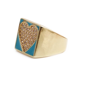 Macro shot of gold wide band ring with teal heart enamel and sparkling zircon detail