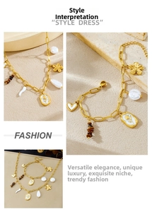 Macro shot of gold-tone necklace and bracelet set with pearls, flowers and heart charms