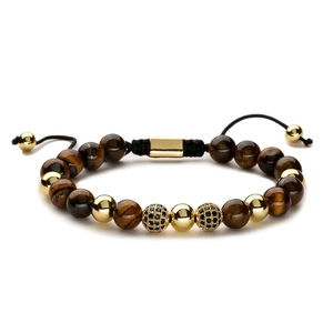 Handwoven tiger eye beaded bracelet with gold accents and zircon beads on white background