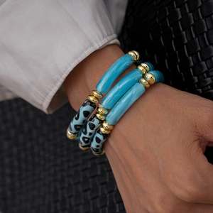 Detail of three-piece blue and leopard print acrylic tube beaded stretch bracelets set