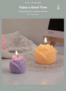 Detailed view of three colorful rose-shaped scented candles on a glass tray with warm lighting