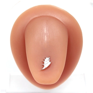 Detailed close-up of a silver bat-wing tongue ring on a silicone ear model display