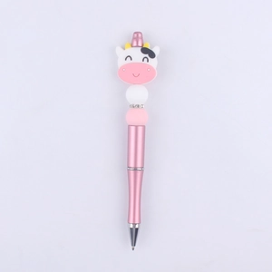 Close-up of pink cow silicone bead pen with sparkling rhinestone and metal barrel