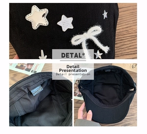 Detail of star patches and plush bow on a black cotton baker boy hat with inner label