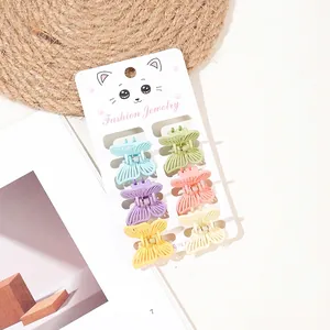 Set of 6 colorful butterfly mini hair claws in pastel shades on a white card