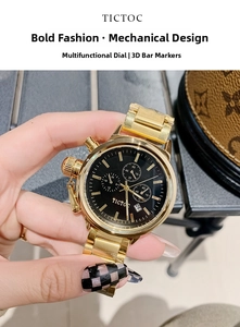Close-up of golden steel watch featuring black multi-function dial and gold markers