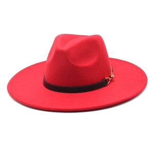 Detail of red wool fedora with wide flat brim and black leather band with gold buckle