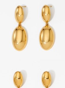 Detail view of glossy gold teardrop earrings with a smooth polished metallic finish