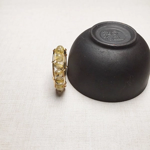 Detail of 14K gold filled wire wrapped ring featuring natural rutilated quartz beads
