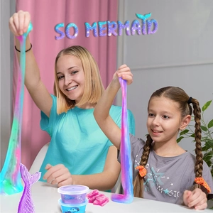 Two girls stretching colorful mermaid slime from the DIY ice cream slime kit