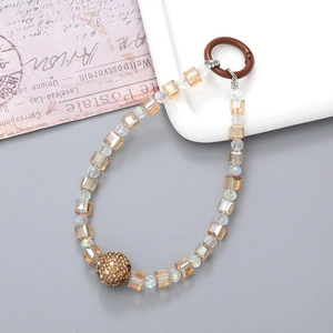 Detail of champagne gold crystal bead phone strap with rhinestone and round ring buckle