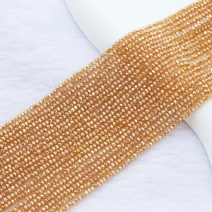 Macro shot of 2mm golden faceted crystal beads for DIY handmade jewelry crafting