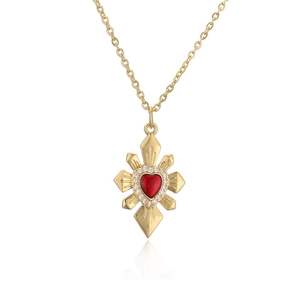 Gold starburst necklace with a red heart pendant and shimmering white crystals