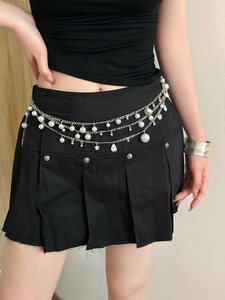 Detail view of silver layered waist chain with faux pearls, star, and shell charms