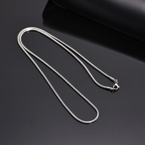 Polished silver stainless steel snake chain necklace for women on dark background