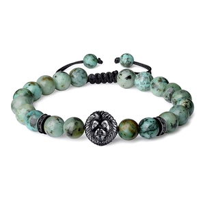 Detail of beaded bracelet with 8mm tiger eye stones and a lion head charm on woven cord