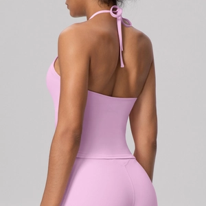 Detail view of open back design on lilac pink yoga top showing elastic fabric texture
