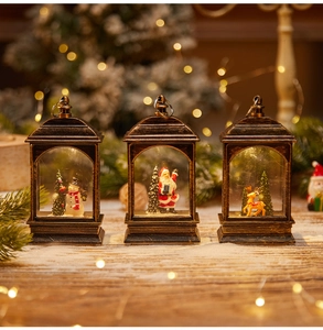 Close-up of three vintage bronze Christmas lanterns featuring snowman and Santa inside