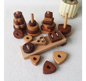 Detail of multi-shape wooden Montessori blocks on a textured mat for early learning