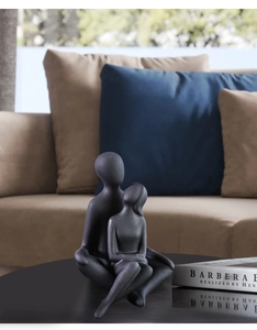 Detailed texture of dark grey matte ceramic couple sculpture in modern artistic style