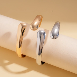 Irregular smooth oval open cuff bangle in gold and silver finish for women