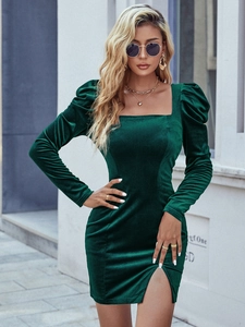 Detailed texture of dark green velvet dress featuring square neck and split skirt