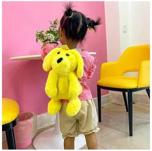 Macro shot of soft yellow plush puppy backpack texture and cute cartoon animal features