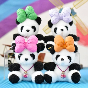 Macro view of four cute panda plush charms with colorful bows and glitter pendants.