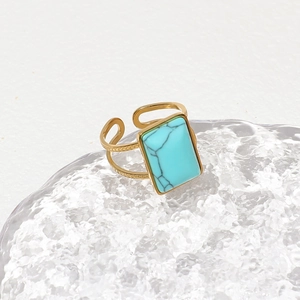 Adjustable golden ring with rectangular turquoise stone and textured metal band