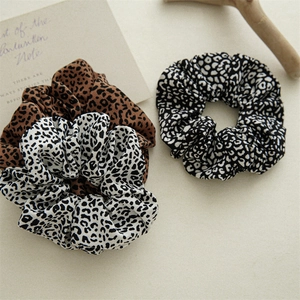Close-up of leopard print hair scrunchies set in soft fabric for versatile styling