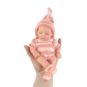 Realistic 8-inch mini reborn baby doll in pink striped outfit sleeping on a palm