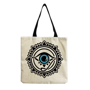 Macro detail of high-quality canvas fabric texture and blue evil eye print on tote bag