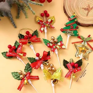 Detail of Christmas cake toppers featuring festive bells and berries on a wooden background