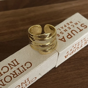 Close-up of gold-plated S925 sterling silver ring showing the braided multi-layer design
