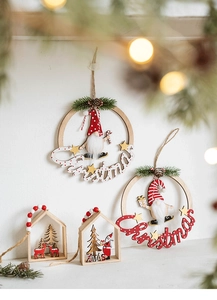 Detail of wooden Christmas ornaments with felt gnomes and reindeer in holiday scenes