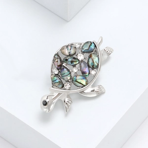 Elegant silver turtle brooch with colorful abalone shell inlay and sparkling rhinestones