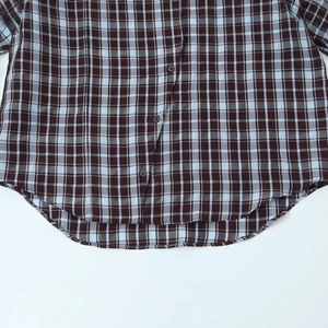 Plaid double-breasted shirt for women with curved hem and button-down front details