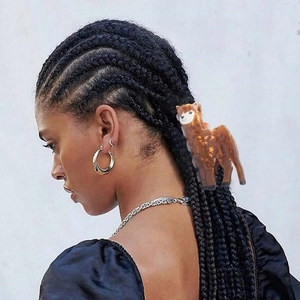 Cute alpaca animal hair claw clip in brown acrylic shown on a braided hairstyle