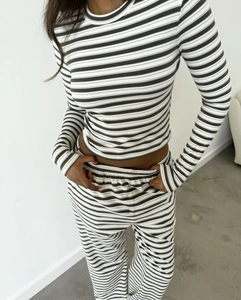 Detailed texture of black and white striped knit long sleeve top and matching pants set