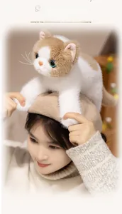 Detailed close-up of a realistic plush cat toy with a beige wool beret on top