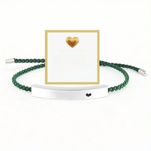 Detail view of woven green rope bracelet with engraved Just breathe stainless steel bar
