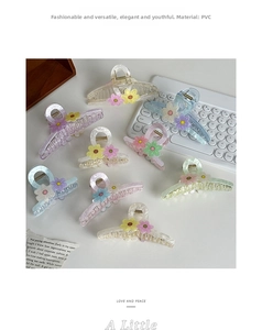 Detail of sweet macaron candy color flower hair claws in pink, blue and purple