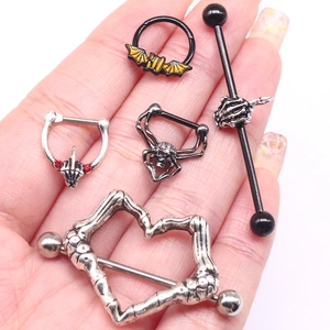 5-piece set of gothic body jewelry with bat, skull, and heart designs in a hand palm view