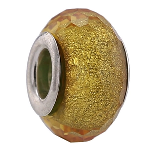 Macro shot of a faceted golden resin bead with a polished silver metal core for DIY bracelets