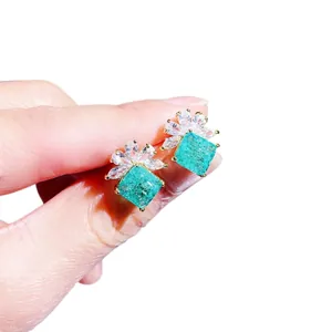 Elegant emerald-style stud earrings with AAA zircon crown design in a gold finish