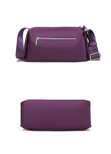 Detalle del bolso bandolera de nailon púrpura con bolsillo trasero y estructura inferior recta